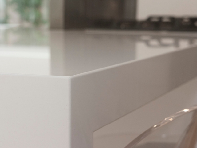 white-stone-kitchen-benchtop-80mm-mitred-edge-barely-visible-join-lines-close-up-artarmon-benchmark-stonemasons.jpg