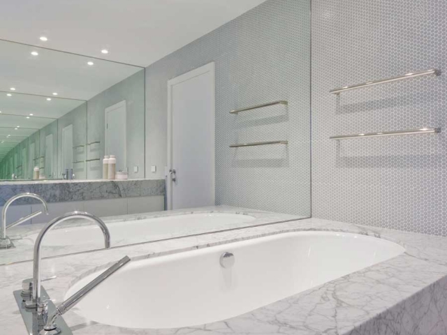 Photo of Glenn McGrath's new bathroom featuring CDK Stone cararra marble bath surround, made by Benchmark Stonemasons, Sydney