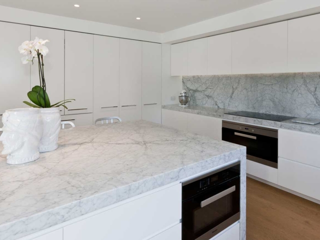 Glenn McGrath's new kitchen featuring CDK Stone cararra marble stone benchtop, made by Benchmark Stonemasons, Sydney