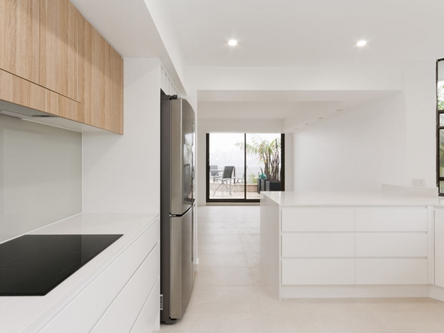 Quantum Quartz Luna White kitchen benchtop, before and after kitchen renovation. Manly apartment renovation by Reno Pack.