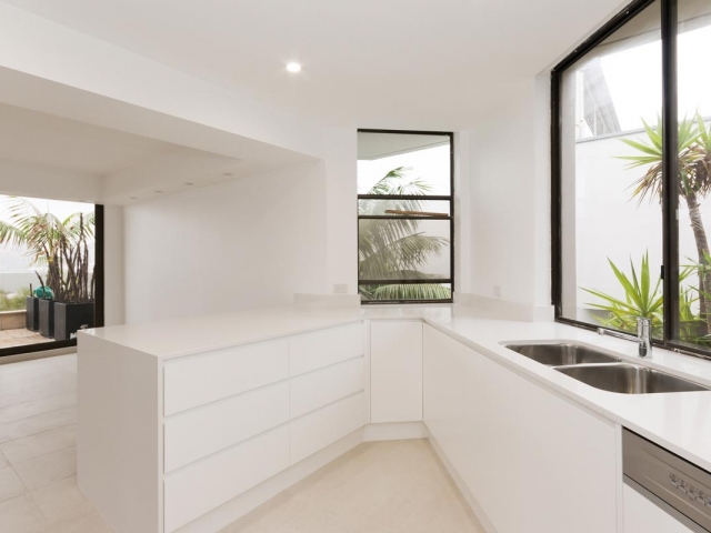 Quantum Quartz Luna White kitchen benchtop, before and after kitchen renovation. Manly apartment renovation by Reno Pack.