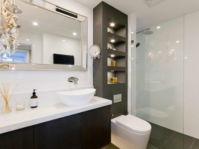 Custom made bathroom vanity featuring Quantum Quartz Statuario Quartz benchtop and splashback. Amalfi above counter basin by Victoria & Albert.