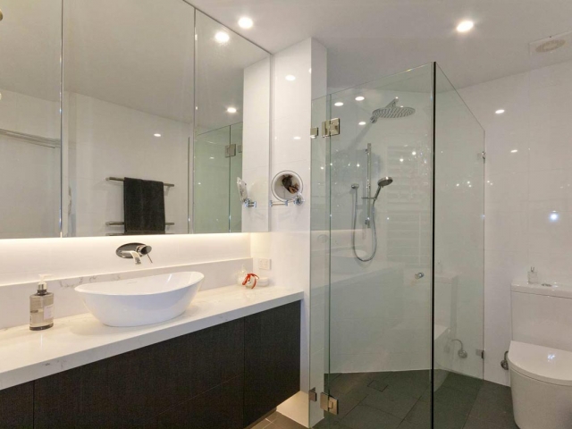 Custom made bathroom vanity featuring Quantum Quartz Statuario Quartz benchtop and splashback. Amalfi above counter basin by Victoria & Albert.