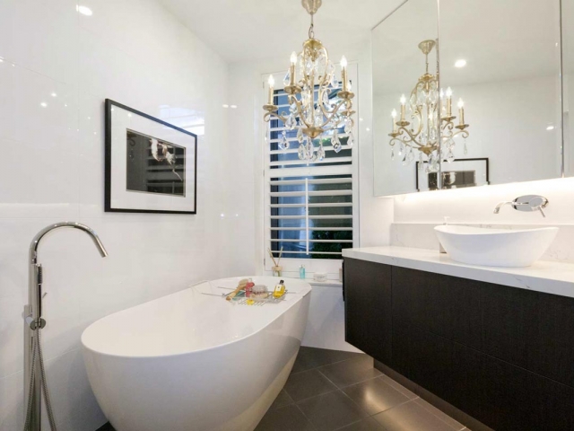 Custom made bathroom vanity featuring Quantum Quartz Statuario Quartz benchtop and splashback. Amalfi above counter basin by Victoria & Albert, freestanding bath by Abey.