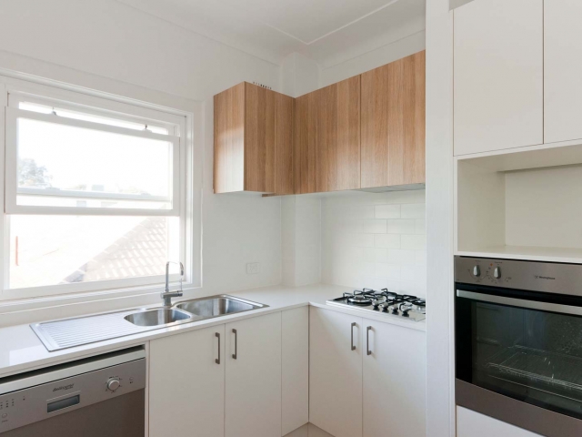 Quantum Quartz stone kitchen bench in Luna White. Unit renovation by Living Space Constructions.