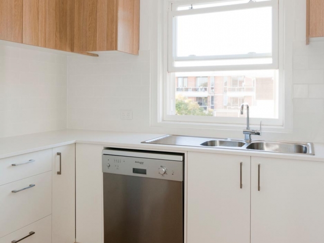 Quantum Quartz stone kitchen bench in Luna White. Unit renovation by Living Space Constructions.