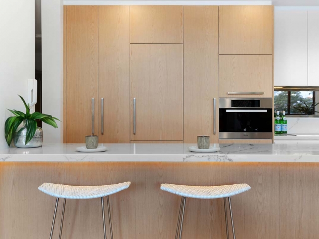 Quantum Quartz kitchen bench in Carrara Quartz. Neutral Bay Apartment renovation by Reno Pack.